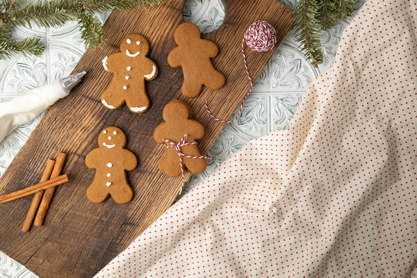Decorating Gingerbread cookies with royal icing for holiday gifts.
