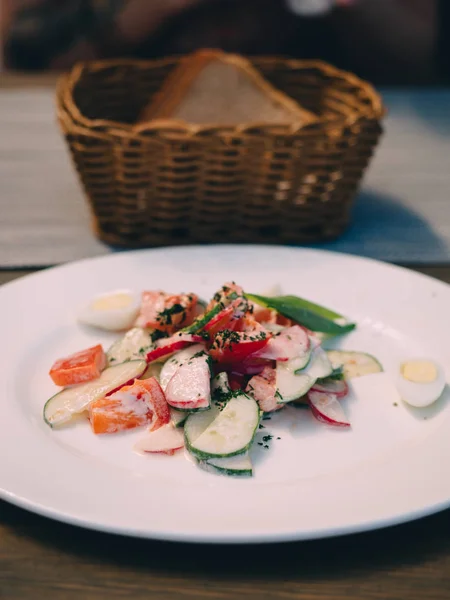 Plate of fresh vegetable salad in cafe table.