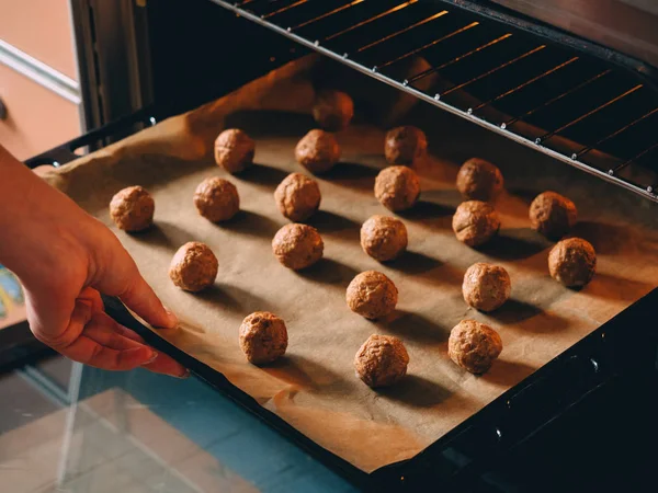 stock image Raw frozen meat balls on baking sheet with paper.