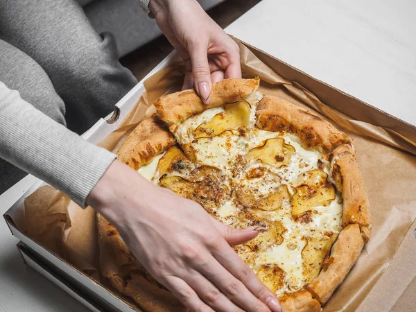 配達箱に梨とドールブルーチーズのピザ。女性の手 — ストック写真