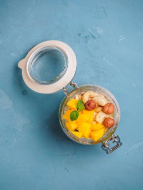 Hindistan cevizi sütü, mango ve fındık ile kavanozda Chia tohum puding