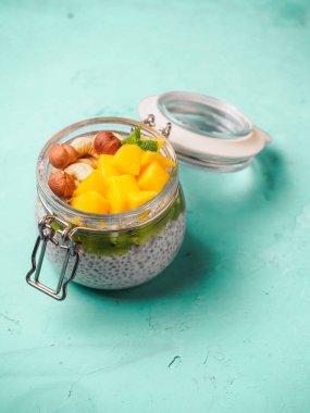 Hindistan cevizi sütü, mango ve fındık ile kavanozda Chia tohum puding