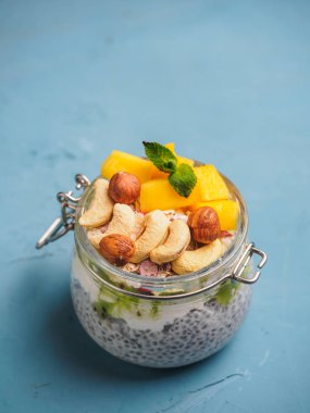 Hindistan cevizi sütü, mango ve fındık ile kavanozda Chia tohum puding