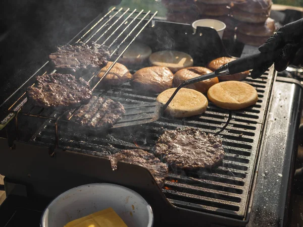 Cooking burgers with beef meat in grill bbq street festival — Stock Photo, Image