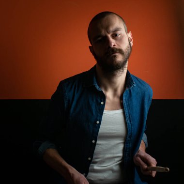 Çocuk kot gömlek ve koyu arka plan ile davul çalmaya