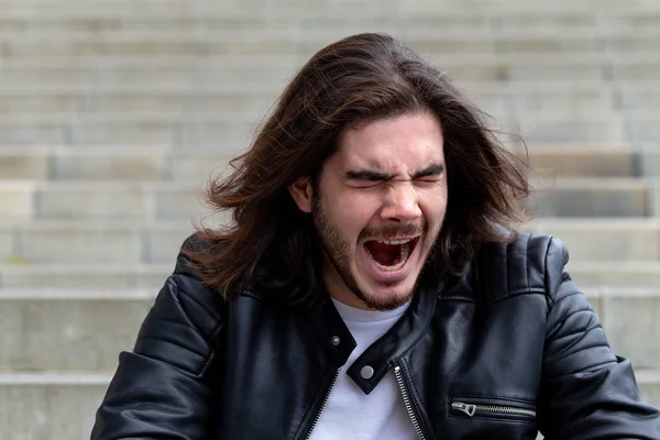 Handsome young bearded man posing outside on copy space