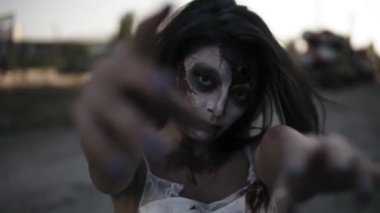 Yaralı yüz ve clawing olan bir tüyler ürpertici zombi kadın portresi ile endüstriyel bir terk edilmiş yer üzerinde arka plan açık havada yürüyüş eller. Cadılar Bayramı, filme, ürkütücü kavramı