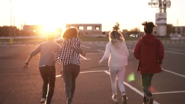 Група Чотирьох Стильних Друзів Біжить Порожньою Паркувальною Зоною Відкритому Повітрі — стокове відео