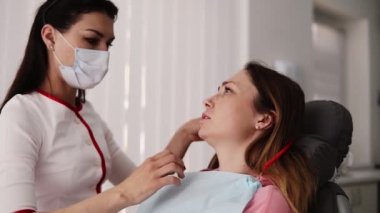 Doktor ofisinde ilk konsültasyon. Kadın hasta sorunları anlatıyor. Uzun saçlı kadın diş hekimi erkek hastayı diş tedavisine hazırlar. Maskeli doktor bir kapak napking koyarak