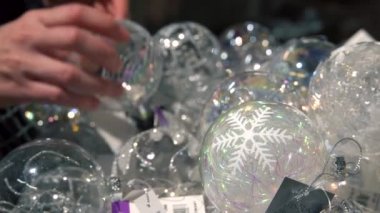 Noel ağacı için güzel topları içinde belgili tanımlık çarşı seçerek bir kişinin elleri. Bying dekorasyon alışveriş merkezinde bir kadındır. Closeup çekim.