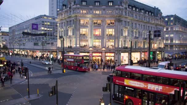 Evening illumination Oxford street crosswalk red double decker buses black cabs. London, UK — Stock Video