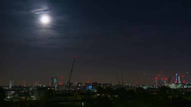 View of the skyline of London with buildings from Primorse Hill under a full moon, London, England, United Kingdom, Europe — Stock Video