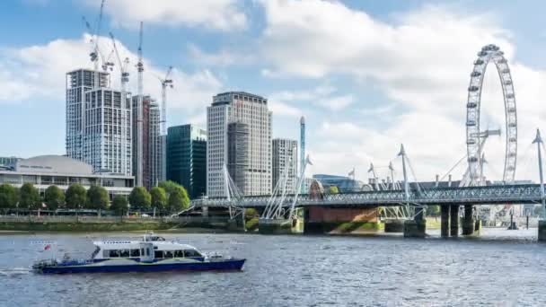 Sunny day ferry boats pass Hungerford Bridge with London Eye and Royal Festival Hall in background. Time lapse. London, UK. — Stock Video