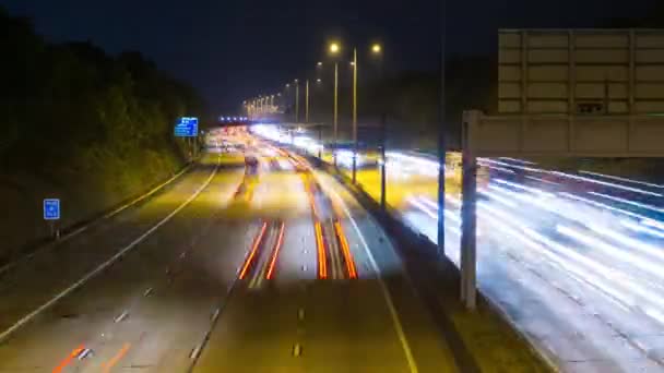 Time Lapse movie of long exposure fast moving speeding freeway auto traffic light trails on M25, England, UK — Stock Video