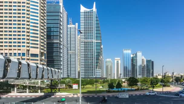 Ponte pedonale che collega i lati nord e sud delle Jumeirah Lakes Towers, traffico su Al Sahel street, JLT Park, Time lapse, Dubai, Emirati Arabi Uniti — Video Stock