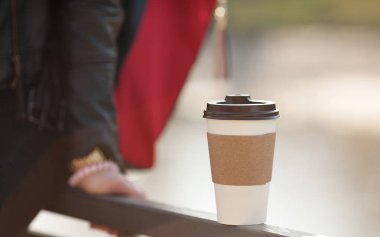 Kağıt bardak kahve ile. Paket servisi olan restoran açık parkta. Arka plan bulanık.