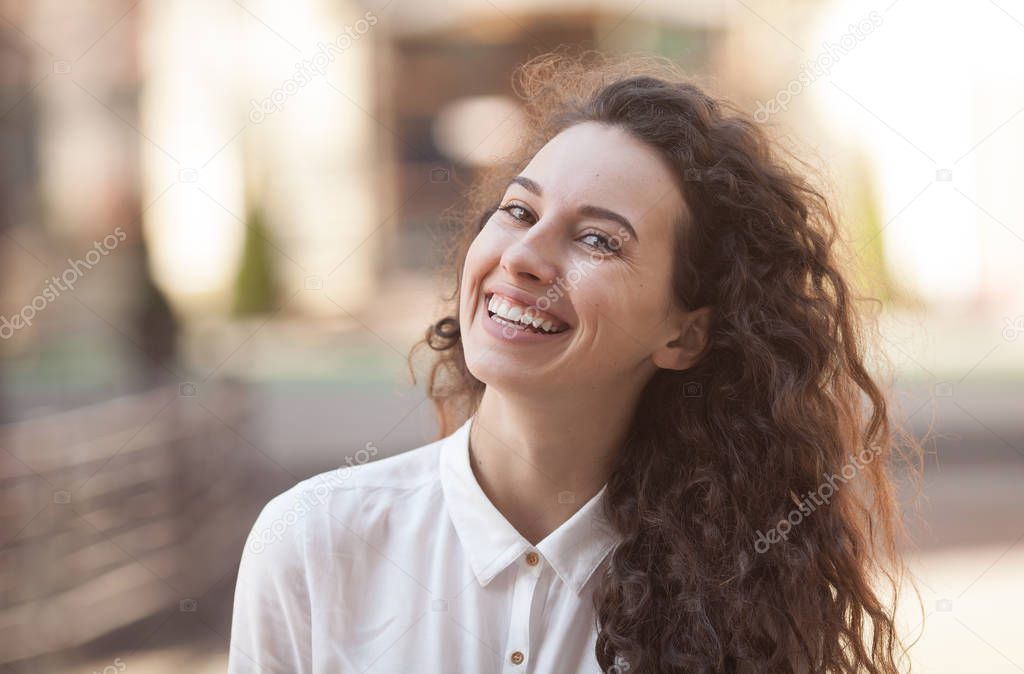 Happiness concept - happy woman having fun on city street during summer