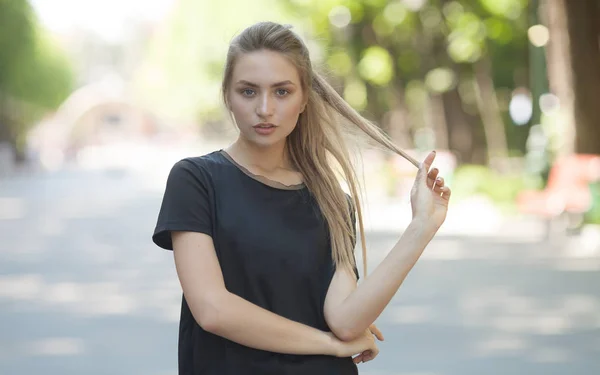 Attractive young woman enjoying her time outside in park with sunset in background.