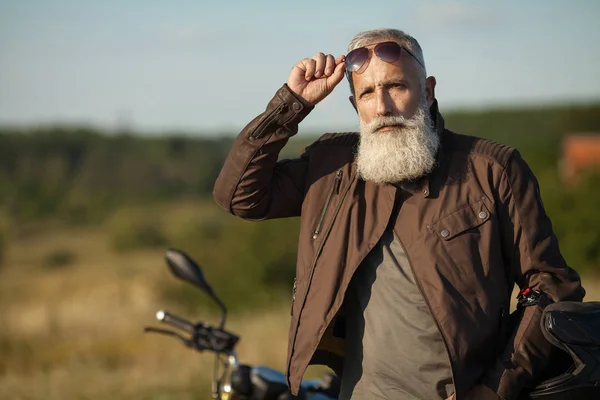 Portrait of a senior man outdoors. Old biker portrait.