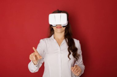 Sanal gerçeklik (Vr) gözlüklü genç kadın. Kırmızı zemin üzerine izole