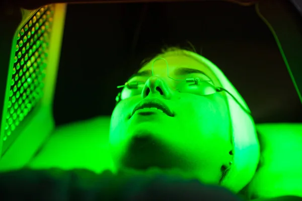 Genç kadın güzellik salonu LED ışık yüz tedavisi sahip