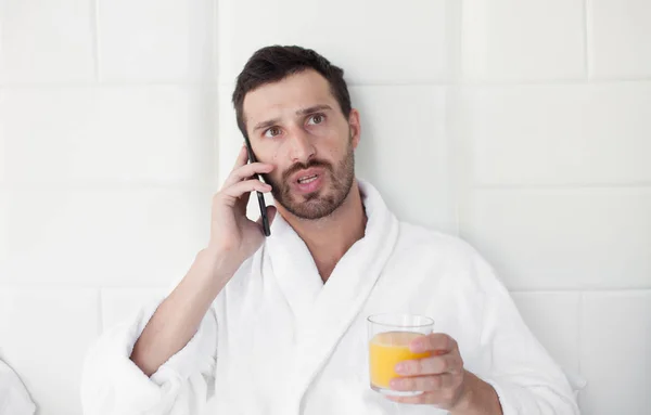 Man making some important calls after waking up