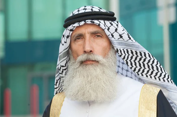 Outdoor Portrait of serious bearded Senior Arab man.