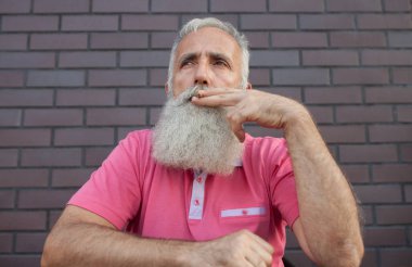 Bıyıkları ve pembe bir t-shirt yasaktır sakallı yaşlı adam.