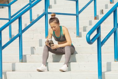 Yaz merdivenlerde, güzel kadın içme suyu. Sağlıklı yaşam konsepti
