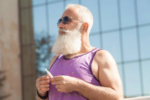 bearded senior man vaping
