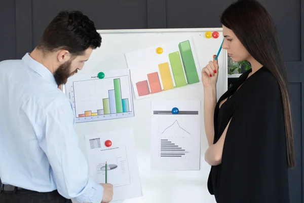 Future business leader concept. Group of young business team discussing work together in modern office. Handsome white business man and beautiful woman reviewing work together on white board.