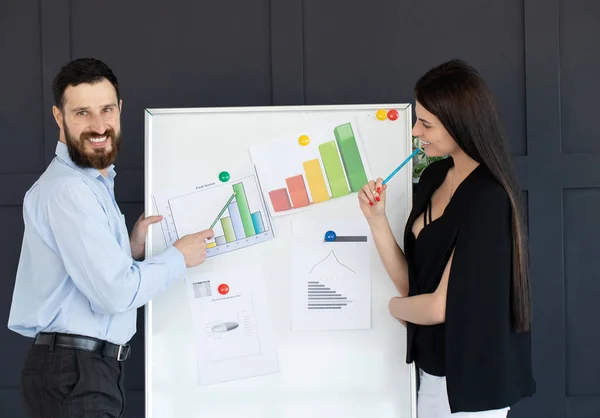 Future business leader concept. Group of young business team discussing work together in modern office. Handsome white business man and beautiful woman reviewing work together on white board.