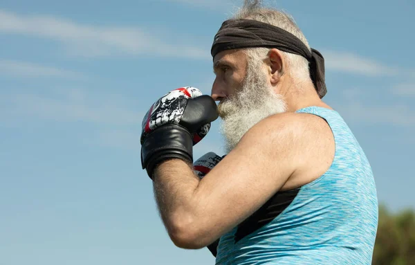 健康な戦闘機高齢者ボクシング手袋ひげそり ボクシングのグローブとボクサー ボクシングキックを練習ハンサムな成熟した男 — ストック写真