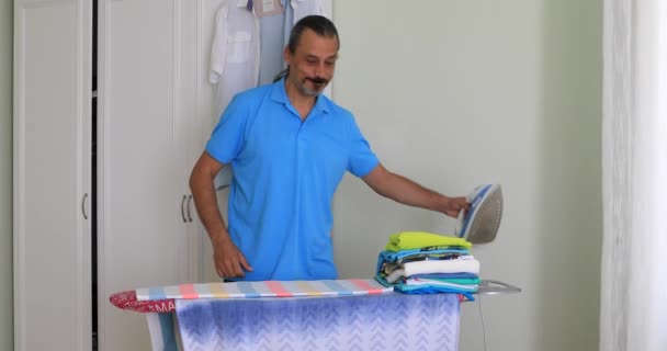 Hombre Mediana Edad Planchar Ropa Con Plancha Eléctrica — Vídeo de stock