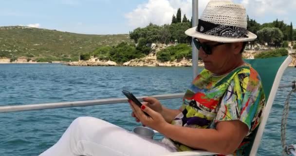 Mujer en yate usando smartphone en las vacaciones de verano 2 — Vídeo de stock