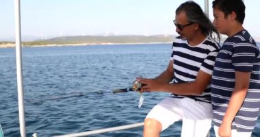 Baba ve oğlu yaz tatilinde teknede balıkçılık 4