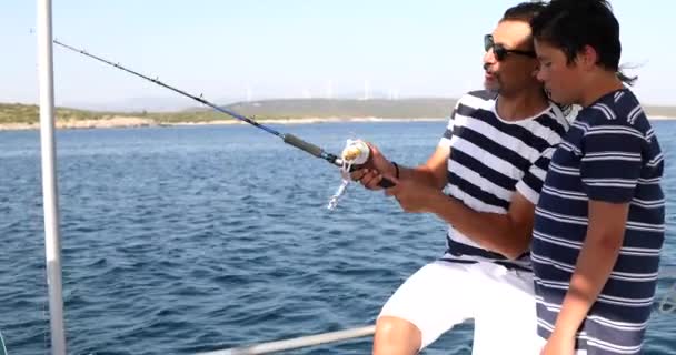 Father and son fishing on boat at summer vacation 3 — Stock Video