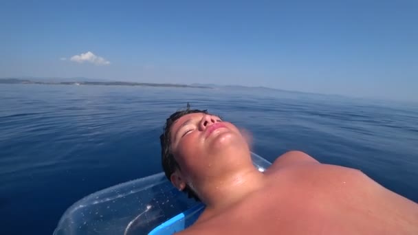 Young boy floating on an air mattress at summer vacation 6 — Stock Video