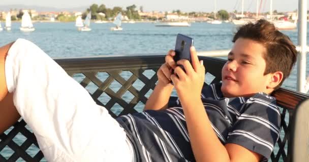 Enfant sur le pont du yacht avec smartphone 7 — Video