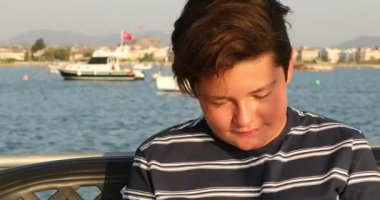 Gülümseyen ve kameraya başparmak gösteren bir gencin portresi 2