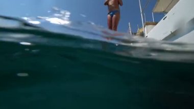 Mutlu genç çocuk güneşli yaz gününde tekne denize atlama 2