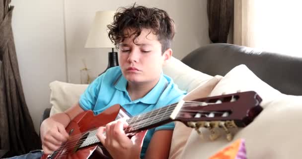 Young boy playing classic guitar at home 5 — Stock Video