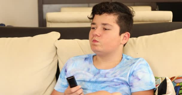 Teenage Boy Remote Controller Chewing Bubble Gum Watching Home — Stock Video