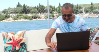 Lüks yattaki beyaz bir turistin portresi yaz tatilinde müzikle rahatlıyor.