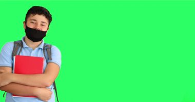 Yeşil ekranda sırt çantası olan üzgün bir okul çocuğu.