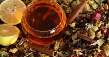 Bir fincan sağlıklı çay, farklı türde kurutulmuş otlar ve çiçekler.
