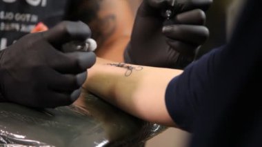 Salon dövme. Dövme sanatçısı çalışma. Dövme sanatçısı stüdyoda dövme yapmak.