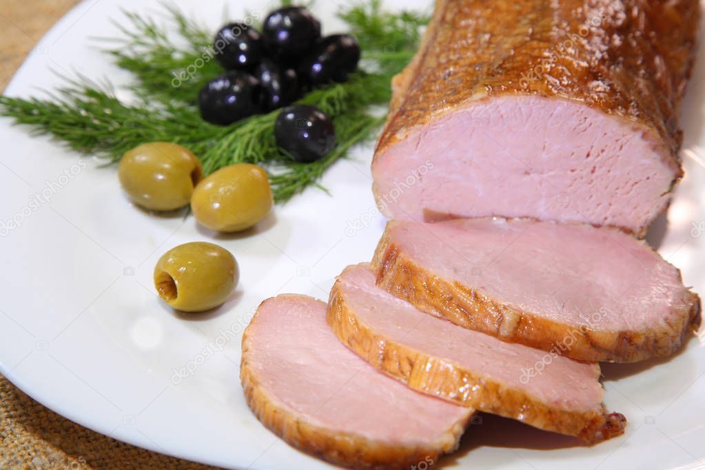 Closeup of a sliced piece smoked ham. Smoked meat. 
