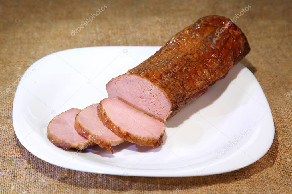 Smoked meat. Closeup of a sliced piece smoked ham