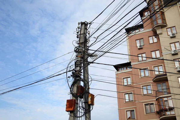 An example of how you can not build Internet connections. Web of wires on the city post. Uncovered optical fiber technology open air outdoors in russian cities.